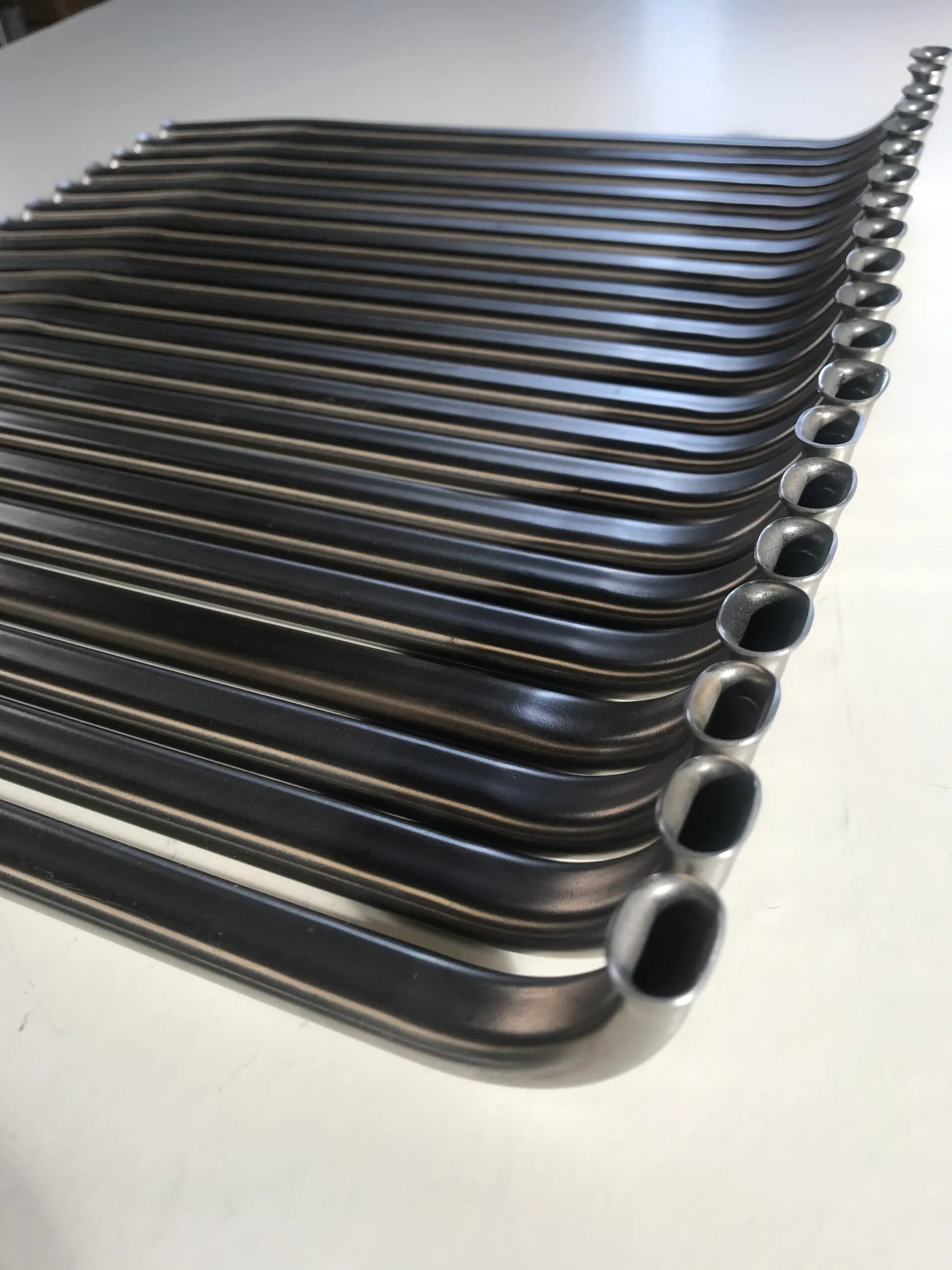 multiple lenghts of stainless steel flat-sided oval tubing with flared ends for use in aviation fuel system